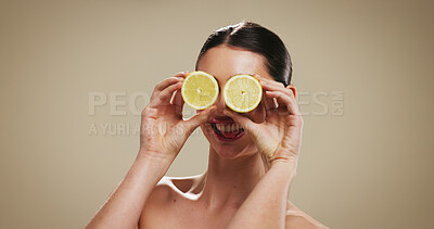 Buy stock photo Happy woman, face or lemon with eyes for skincare or vitamin C on a studio background. Female person, model or smile with natural organic fruit for fiber, detox or health and wellness on mockup space