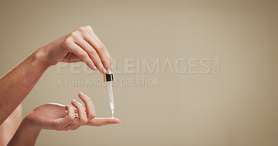Buy stock photo Beauty, serum and hands of person in studio for hyaluronic acid, skincare and anti aging. Mockup space, dermatology and finger with dropper for cosmetics, collagen and retinol on brown background