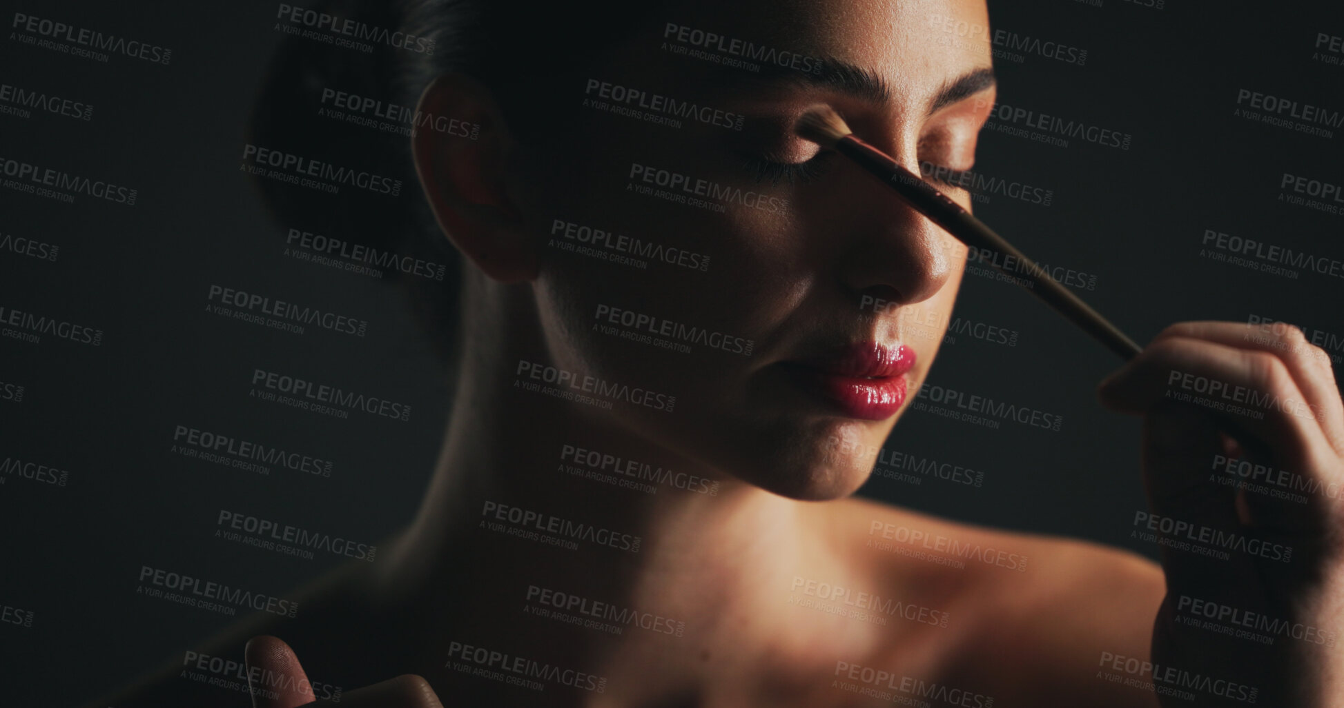Buy stock photo Makeup, brush and woman in studio with eyeshadow, beauty or facial routine with products. Cosmetics, self care and female person with tool for face cosmetology treatment for glow by black background