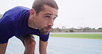 Runner, man and ready to start on track for cardio exercise, marathon training and race practice. Athlete, set and running take off at stadium for competition fitness, endurance challenge and space
