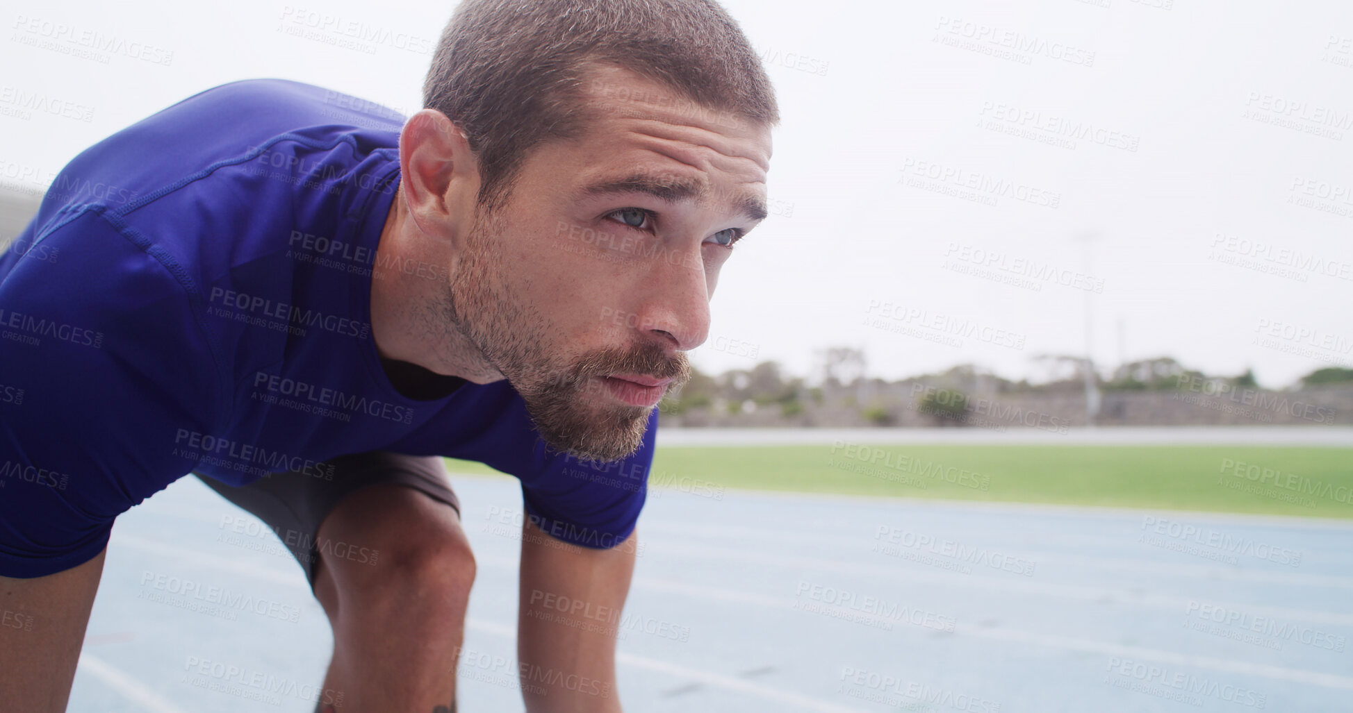 Buy stock photo Runner, man and ready to start on track for cardio exercise, marathon training and race practice. Athlete, set and running take off at stadium for competition fitness, endurance challenge and space