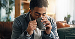 Coffee, happy and man on sofa in home with calm, peace or morning break with warm beverage. Smile, relax and male person drinking cappuccino, latte or tea for wellness in living room at apartment.