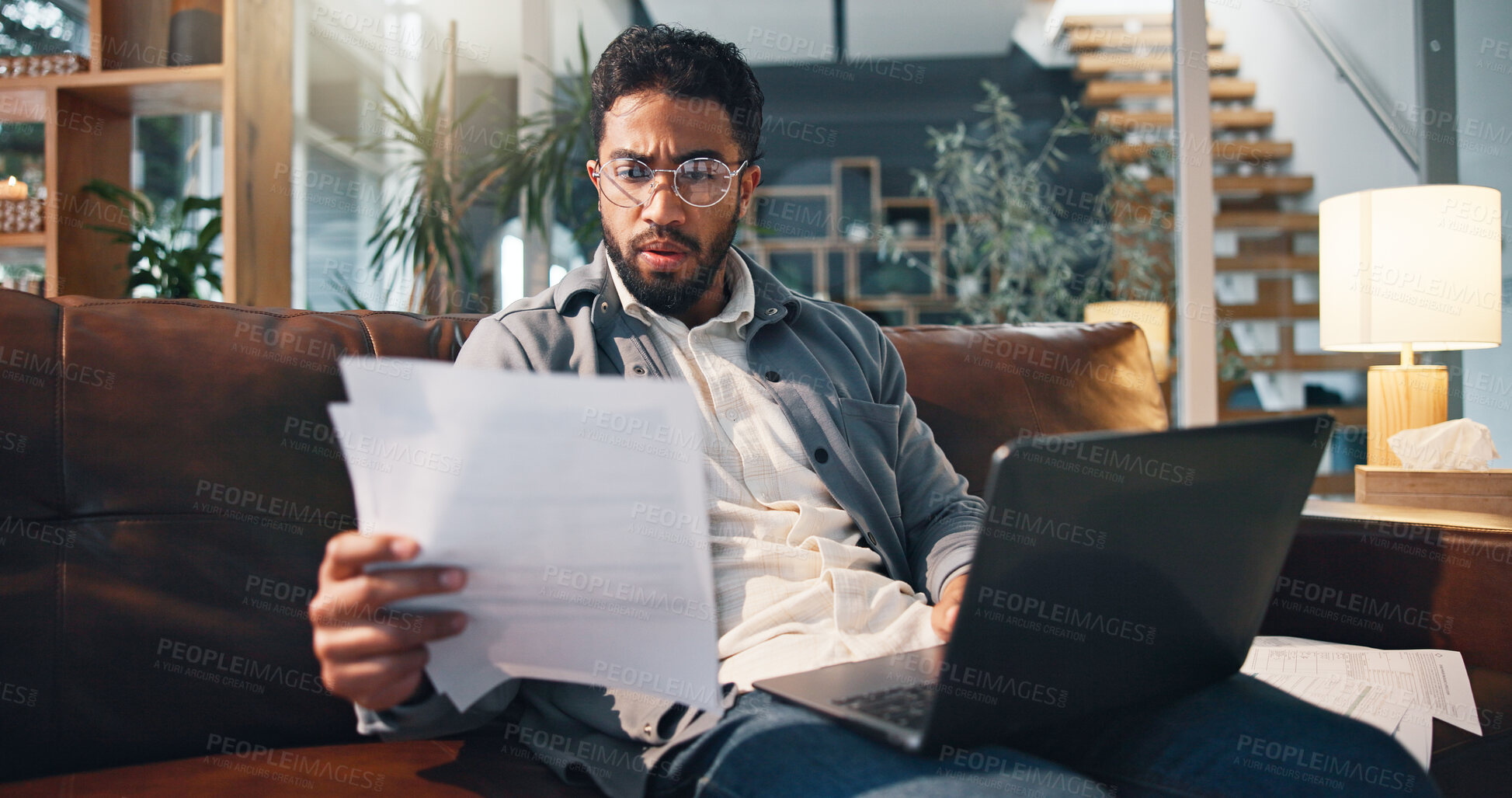 Buy stock photo Stress, document and man with bills in home for debt, rent and mortgage cost with laptop. Banking, expenses and person with paper in living room for financial crisis, taxes and bankruptcy with loan