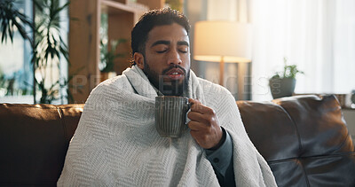 Buy stock photo Sick, drink and blanket with man on sofa for medicine, sore throat relief and recovery. Illness, flu and herbal tea with person and mug in living room of home for allergy, virus and infection
