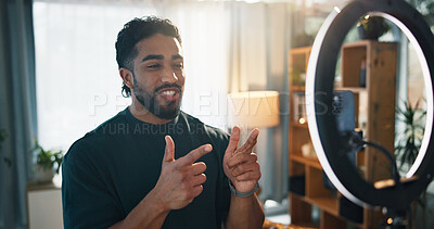 Buy stock photo Man, influencer and ring light with recording in home for content creation, video or finger gun on web. Person, talk and greeting for online audience, emoji and live stream on social media at house