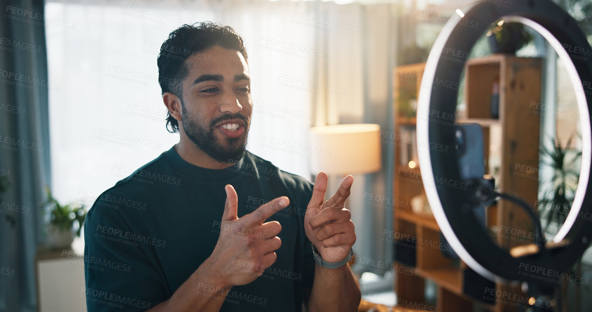 Buy stock photo Man, influencer and ring light with recording in home for content creation, video or finger gun on web. Person, talk and greeting for online audience, emoji and live stream on social media at house