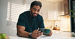 Happy man, phone and coffee in kitchen, texting and check notification with online dating at home. Person, smartphone and smile with tea cup, mobile app and scroll on social network at apartment