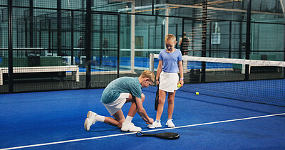 Buy stock photo Padel, sports and children tie shoes on court for workout, exercise and training together. Tennis club, siblings and boy help girl with sneakers for playing game, match and practice for tournament