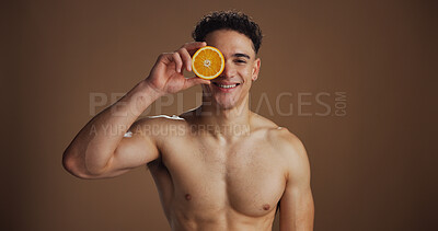 Buy stock photo Portrait, man and skincare with orange, studio background and natural cosmetics for facial treatment. Soft, glow and smooth skin with fruit, healthy or dermatology for wellness or self care in USA