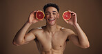 Portrait, man and skincare with grapefruit, studio background and natural cosmetics for dermatology. Soft, glow and smooth skin with fruit, health or facial treatment for wellness or self care in USA