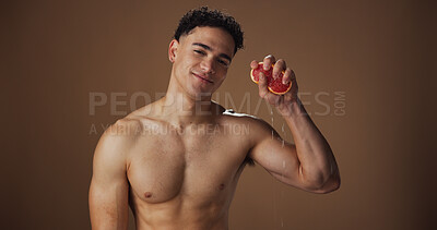 Buy stock photo Portrait, man and skincare with grapefruit, healthy and smile for natural cosmetics and dermatology. Studio background, glow and clear skin with fruit, self care and facial treatment for wellness