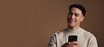 Man, phone and happy with thinking in studio with mockup space, decision and online dating on background. Person, smile and click on smartphone with chat, texting or mobile app for social network