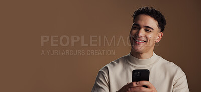 Buy stock photo Man, phone and happy with thinking in studio with mockup space, decision and online dating on background. Person, smile and click on smartphone with chat, texting or mobile app for social network
