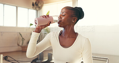 Buy stock photo Pilates class, woman and drinking water in studio for hydration, exercise break and nutrition. Fitness, black person and thirsty with liquid bottle for workout recovery, wellness or rest from routine