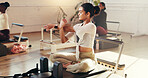 Woman, fitness or stretching with arms in gym for physical exercise or group workout session. Female person, warm up or flexibility with reformer for pilates class, balance or wellness in health club