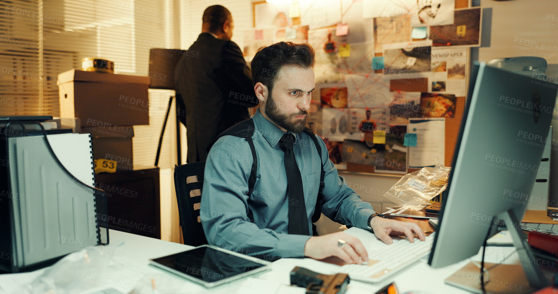 Buy stock photo Man, detective and research on computer in office for police records, evidence report or deadline. Night, colleagues and criminal database for crime investigation, case review or monitor surveillance