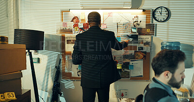 Buy stock photo Detective, back of man and board with evidence for case, investigation and criminal lead at police station. Investigator, problem solving and documents on mindmap with suspect of crime at night
