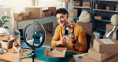 Buy stock photo Headphones, logistics and phone recording with man in studio for advertising or product review. Boxes, ring light and supply chain with employee in workshop for delivery, ecommerce or shipping