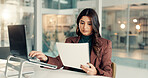 Woman, documents and reading with laptop in office for company finance, budget planning or report. Female person, accountant or analyst with paperwork on computer for financial expenses in workplace