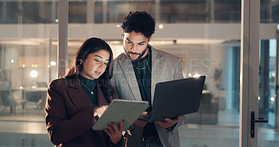 Buy stock photo Laptop, night and tablet with business people in office together for collaboration or meeting. App, conversation and technology with employee team in workplace for evening feedback or review