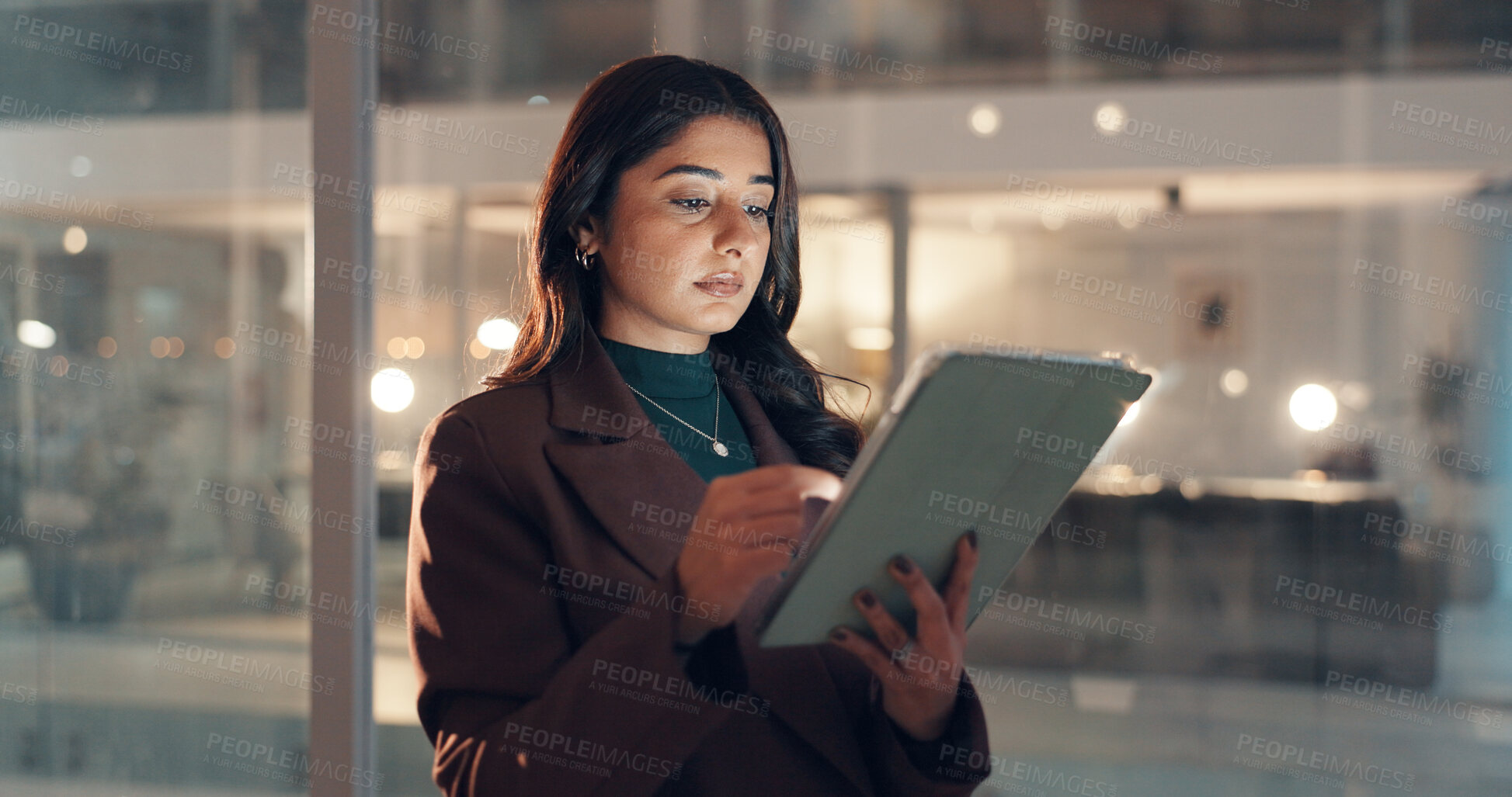 Buy stock photo Business woman, night and tablet in workplace for research, policy review or insurance. Technology, serious broker and online in office for reading email with claims, update and bokeh on overtime
