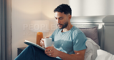 Buy stock photo Bedroom, reading and man with tablet, coffee or relax on bed, digital info or subscription for news. Serious, reader and browsing article updates on website, technology and person with tea in house