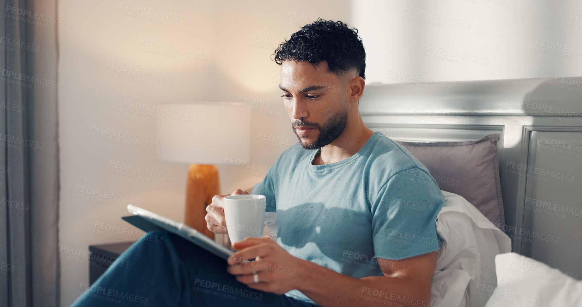 Buy stock photo Bedroom, reading and man with tablet, coffee or relax on bed, digital info or subscription for news. Serious, reader and browsing article updates on website, technology and person with tea in house