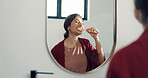 Mirror, brushing and teeth with woman in bathroom for hygiene, oral health and prevent bad breath. Female person, reflection and toothbrush for dental care, remove plaque and cleaning mouth at house