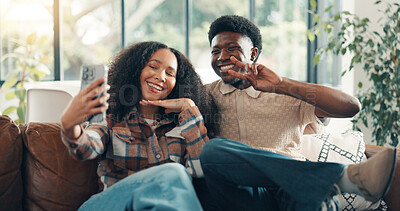 Buy stock photo Home, selfie and couple on sofa, love and bonding together with peace sign, relax and romance. Apartment, profile picture and man with woman, relationship and memory with happiness, smile and gesture