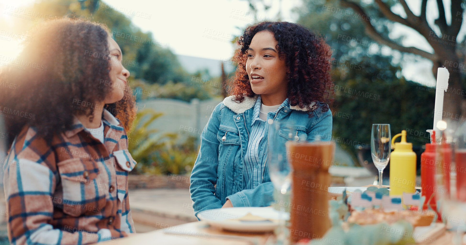 Buy stock photo Friends, women and discussion with lunch outdoor for conversation, bonding and social gathering. Thanksgiving celebration, people and happy together with eating for holiday reunion and weekend break