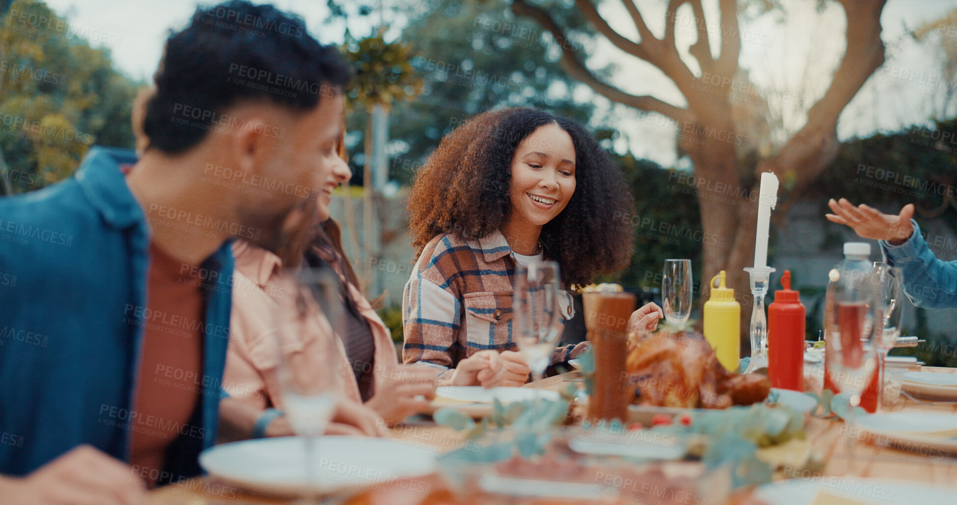 Buy stock photo Friends, laugh and discussion with lunch outdoor for conversation, bonding and social gathering. Thanksgiving celebration, people and happy together with eating for holiday reunion and weekend break