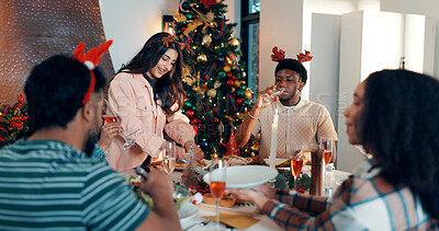 Buy stock photo Woman, serving and food to friends for Christmas celebration, healthy meal and social gathering. Happy, people and dishing turkey of festive cuisine, holiday reunion and eating lunch together in home