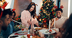 Woman, cutting and chicken with friends on Christmas for celebration, healthy meal and social gathering. People, dishing food and turkey for festive cuisine, holiday reunion and eating lunch at house
