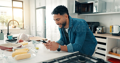Buy stock photo Phone, food and man in kitchen for cooking with online recipe on mobile app in apartment. Happy, cellphone and male person with ingredients for dinner, meal or supper with instructions in home.