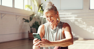 Buy stock photo Phone, smile and old woman in studio for fitness, exercise schedule or information online for health. Mobile, gym or happy senior person check wellness app for pilates, track progress or retirement