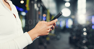 Buy stock photo Fitness, gym and hands of woman with phone on mobile app for health, wellness and track workout. Sports, bokeh and person on smartphone for internet, exercise website and training progress with flare