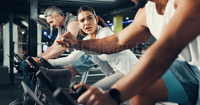 Buy stock photo Fitness, people and fist bump on stationary bike at gym for cardio challenge, training or support. Athlete, woman or motivation in spin class for cycling endurance, teamwork goals or burning calories