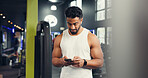 Texting, athlete and man with smartphone, gym and communication with contact on social media or web. Fitness, chat and person with mobile on break, online and typing message with tech in health club