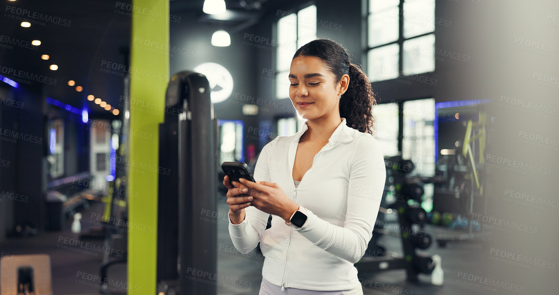 Buy stock photo Phone, smile and woman in gym for fitness, training guide or tracking progress for health stats. Sports club, mobile and happy person check workout schedule, wellness info or online chat with app