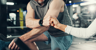 Buy stock photo Fitness, hands and fist bump on stationary bike at gym for cardio challenge, training or support. Athlete, people or motivation in spin class for cycling endurance, teamwork goals or burning calories