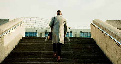 Business, man and walking on steps in city for travel to work, urban journey and career opportunity. Back, male person and stairs with briefcase for morning commute, profession adventure or low angle