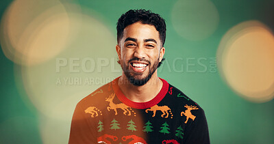 Buy stock photo Happy man, portrait and studio with fashion for christmas or festive holiday on a green background. Excited, male person or model laughing with smile or jersey for december, style or outfit on bokeh