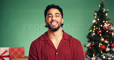 Buy stock photo Studio, Christmas and portrait of man, laughing or festive celebration with decorations or presents. Happiness, person and green background for Xmas season, December or tree with ornaments on holiday