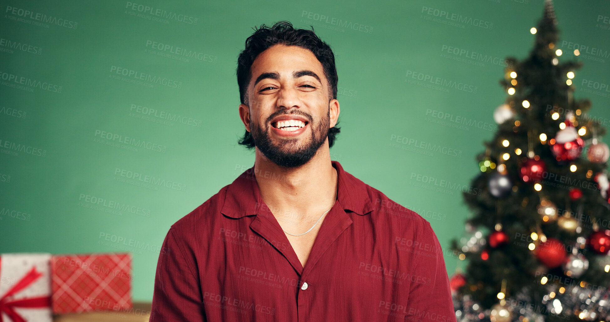 Buy stock photo Studio, Christmas and portrait of man, laughing or festive celebration with decorations or presents. Happiness, person and green background for Xmas season, December or tree with ornaments on holiday