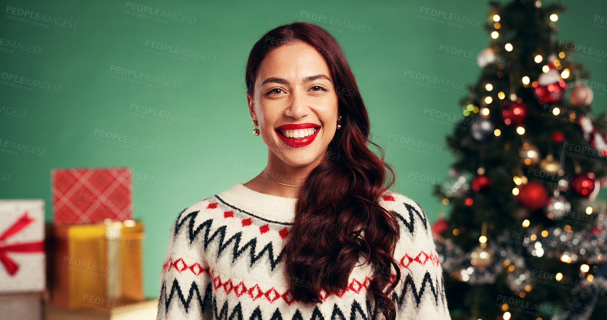 Buy stock photo Happy woman, portrait or christmas with gifts in studio for festive holiday on a green background. Bokeh, female person or model with smile or presents for december party celebration or new year