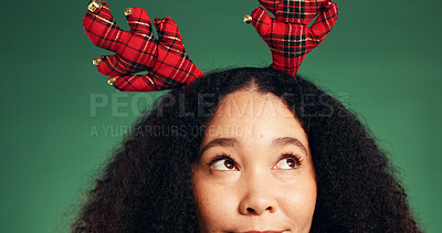 Buy stock photo Christmas, thinking and eyes with woman in studio for decision, holiday season and gift planning. Festive tradition, reflection and vision with person on green background for inspiration and idea