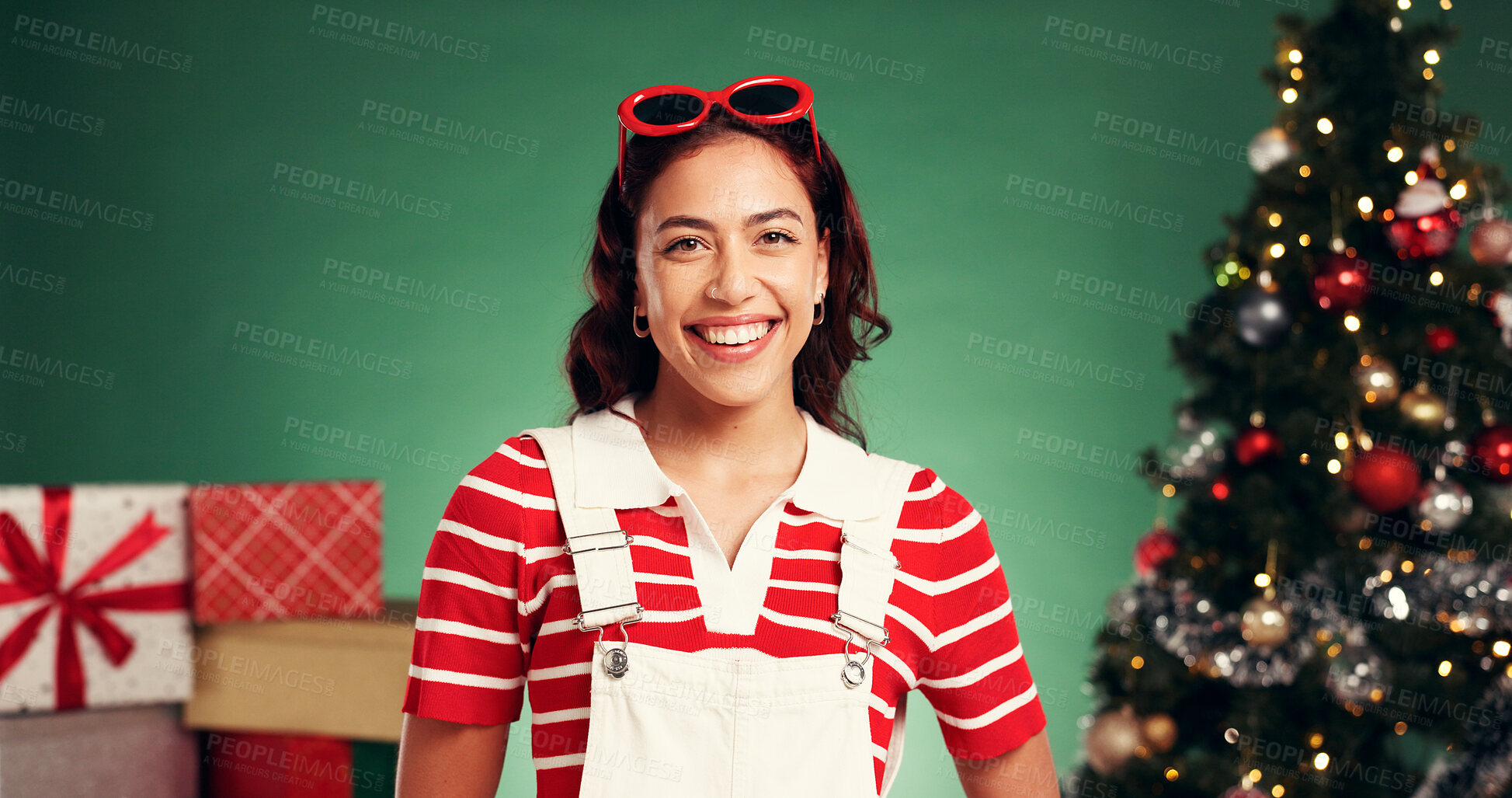 Buy stock photo Portrait, Christmas and woman with smile, studio and December holiday with decorations and presents. Excited, person and green background for Xmas season, celebration or tree with ornaments in USA