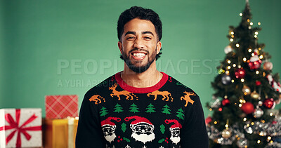 Buy stock photo Studio, man and excited for Christmas, portrait or festive celebration with decorations or presents. Happy, person and green background for Xmas season, December and tree with ornaments on holiday