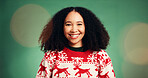 Portrait, woman and smile in studio for Christmas season, celebration and festive tradition. Happy, African person and bokeh with xmas jersey, satisfaction and december holiday on green background