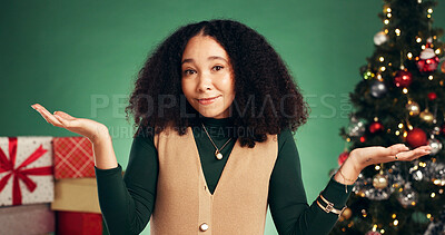 Buy stock photo Christmas, choice and confused with portrait of woman in studio for decision, wish list and holiday season. Option, festive gift idea and xmas offer with person on green background for sale and deal